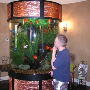me standing by the tank, it is located at the salon my sister designed, dad financed, and mom owns.