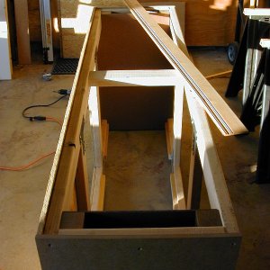 Pretty befy, with 4x4 corner posts and 2x4 framing all around to distribute the weight; skinned in 1/2" OSB and MDF.  The wainscotting laying atop the