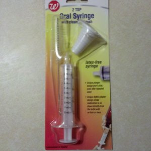 Syringe used to take the 1/2" outflow of the pumps to 3/16" airline tubing.