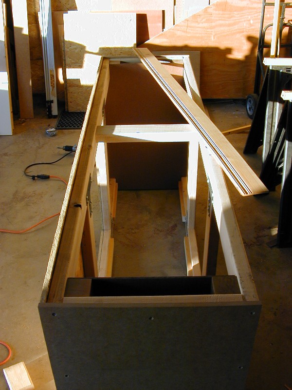 Pretty befy, with 4x4 corner posts and 2x4 framing all around to distribute the weight; skinned in 1/2" OSB and MDF.  The wainscotting laying atop the