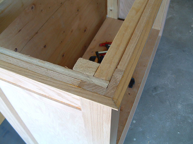 The stand has an internal frame of 2x4s with an oak plywood skin. The outer layer you see here is the molding.
